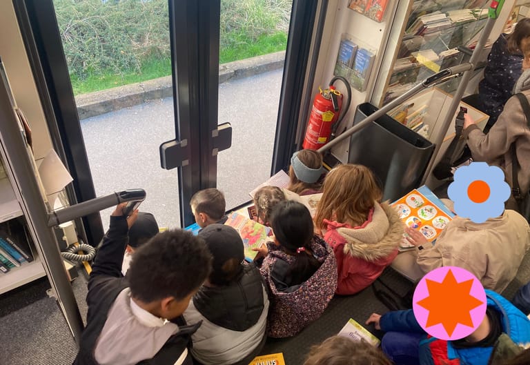 Kinder lesen vertieft in Büchern auf der Stiege in einem Bus